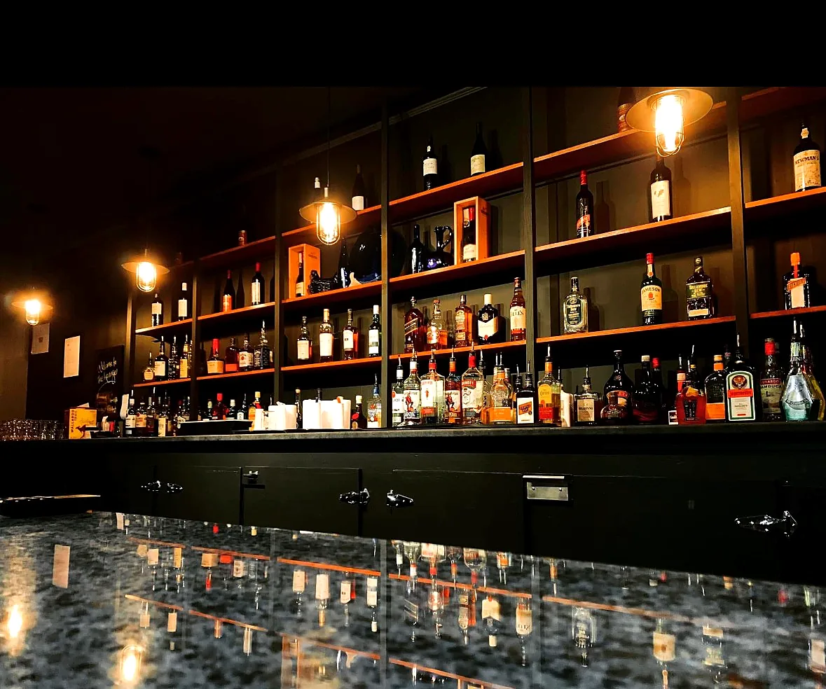 The bar The lit back bar shelves and bottle selection at the Wabush Hotel bar