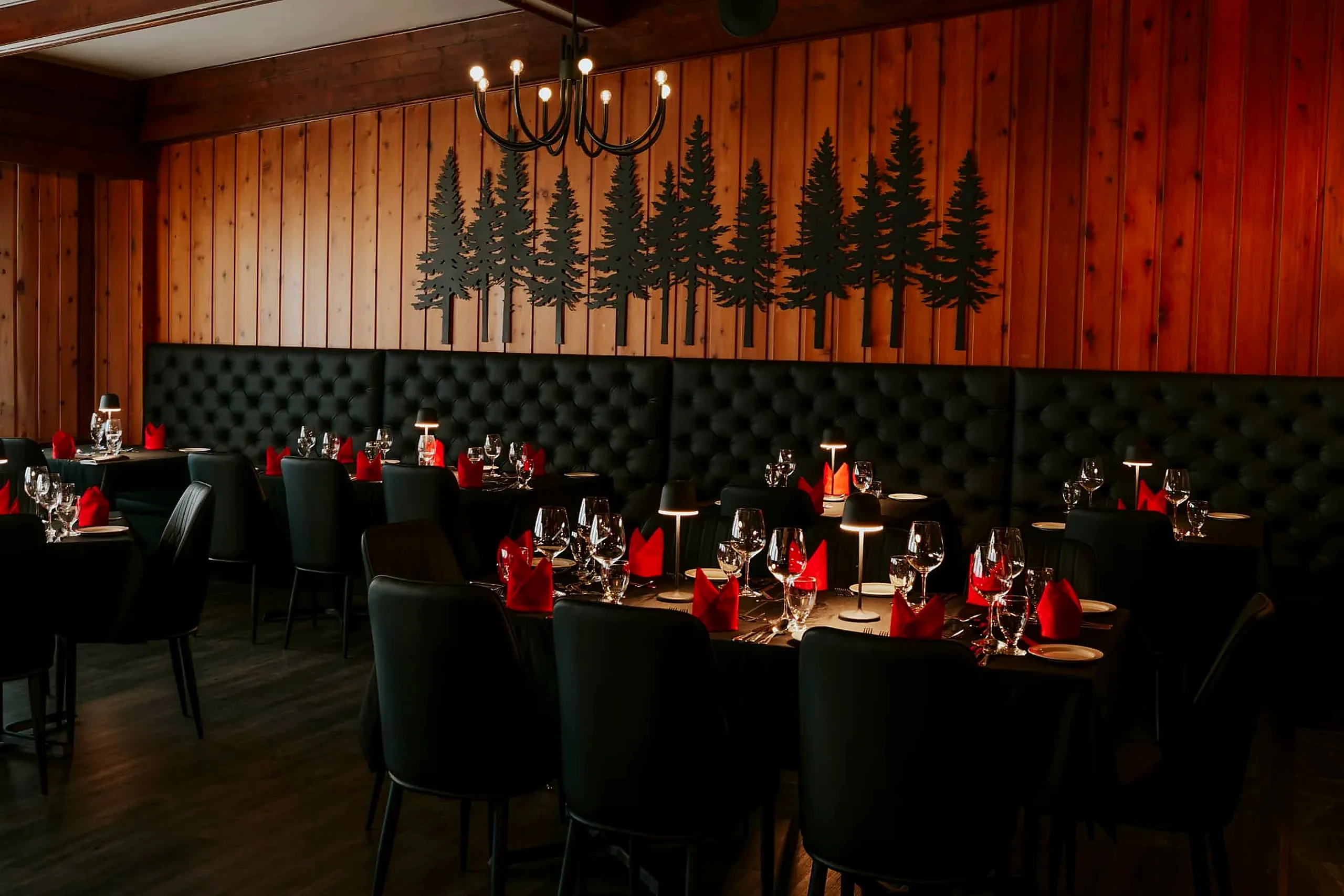 Banquettes and pines Restaurant banquettes under the black pine-tree wall art at the Wabush Hotel
