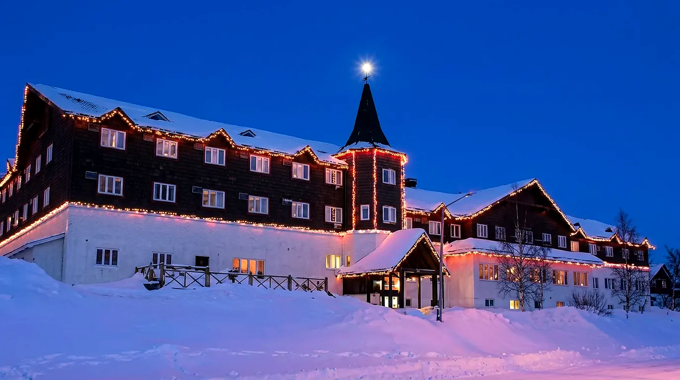 The hotel in winter The Wabush Hotel exterior in winter, snow banked along the dark wood facade in Wabush, Labrador West