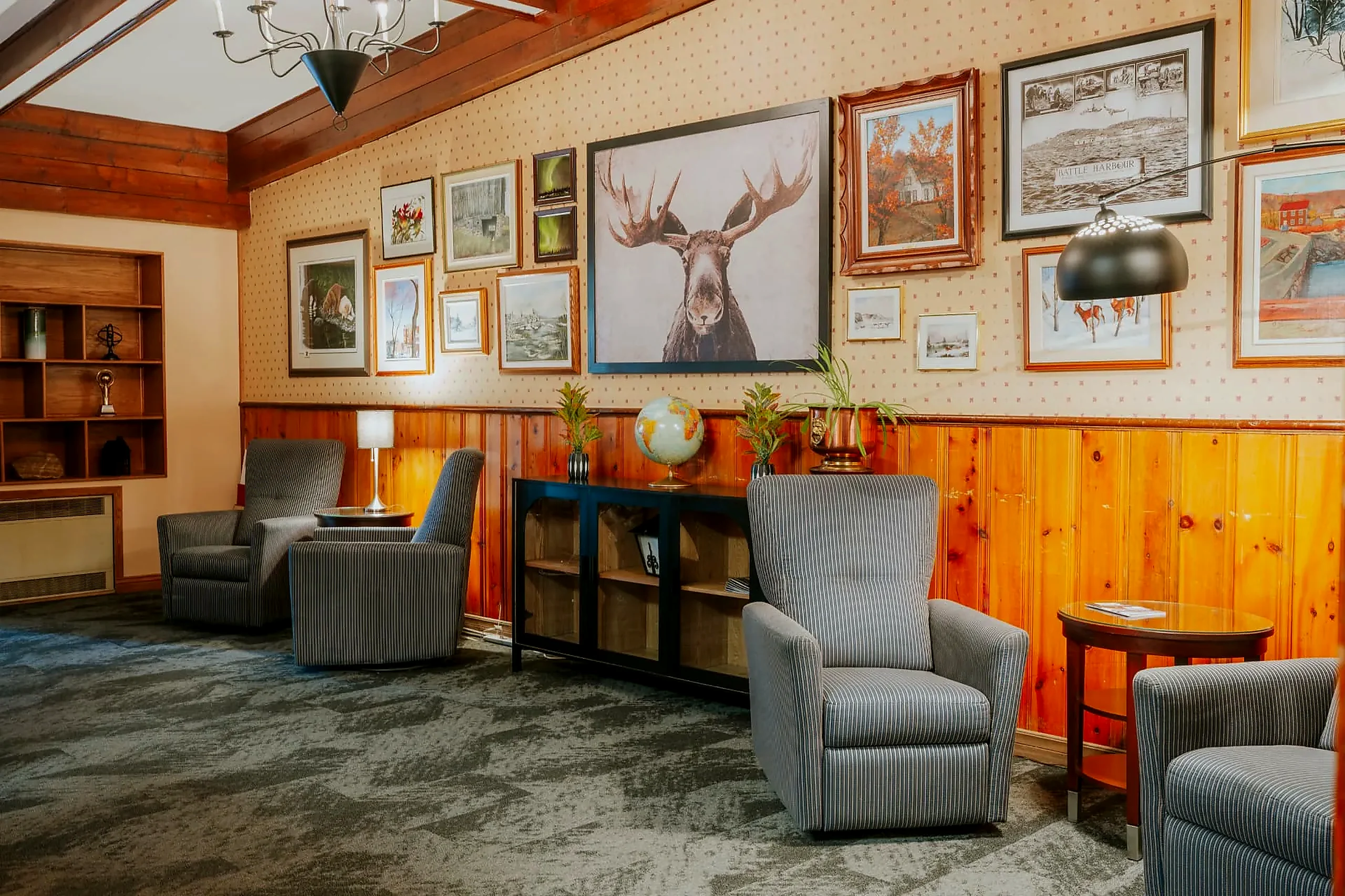 The guest lounge The Wabush Hotel guest lounge with pine panelling, armchairs and framed local artwork