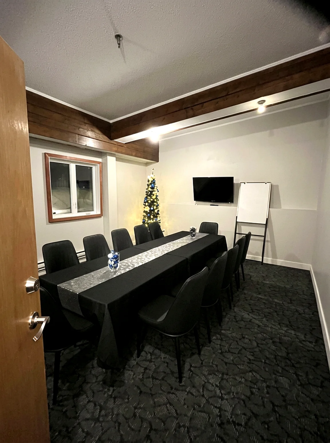 Boardroom setup The small meeting room at the Wabush Hotel set as a boardroom with a wall-mounted TV and flip chart